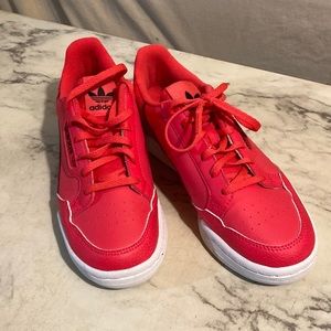 Adidas, size 4.5 boys, 6 woman’s. Neon orange. Never worn outside.